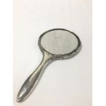 AN EARLY 20TH CENTURY SILVER HAND MIRROR, HALLMARKED BIRMINGHAM 1913, MAKERS MARK RUBBED, 27.5CM