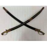 TWO LARGE INDIAN CURVED SWORDS IN SCABBARDS, THE METAL POMMELS SHAPED AS LIONS, 99CM LONG