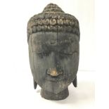 A LARGE CARVED AND PAINTED WOOD BUDDHA HEAD, 35CM HIGH