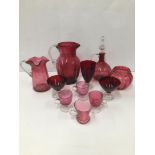 A COLLECTION OF CRANBERRY GLASS ITEMS, INCLUDING A DECANTER, TWO POURING JUG, DRINKING GLASSES AND
