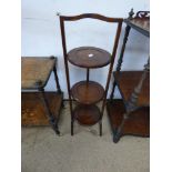 A VINTAGE OAK FOLDING CAKE STAND.