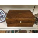 A LATE 19TH/EARLY 20TH CENTURY WALNUT WRITING SLOPE WITH BRASS CORNERS TO THE TOP OF THE BOX, 35CM