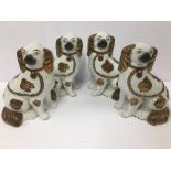 TWO PAIRS OF STAFFORDSHIRE SPANIELS, 22.5CM HIGH