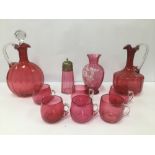 A GROUP OF CRANBERRY GLASS ITEMS, INCLUDING TWO DECANTERS, SUGAR SIFTER AND MORE, LARGEST 27CM HIGH