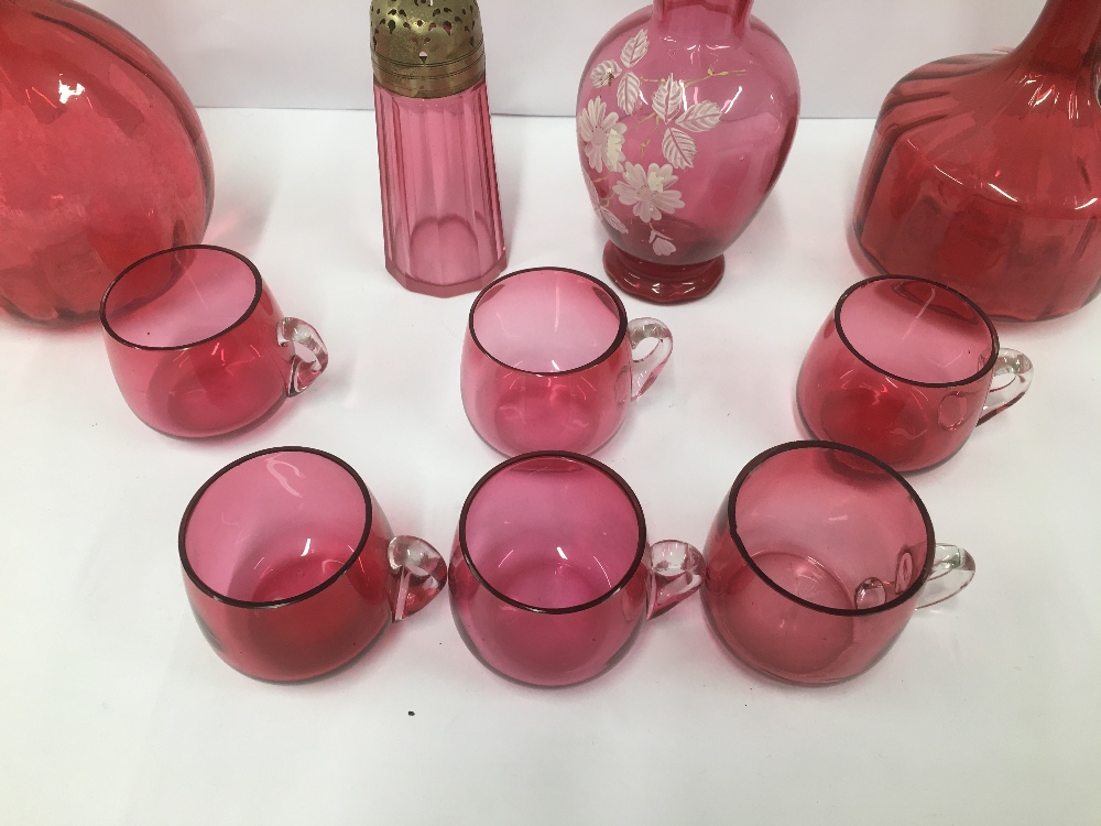 A GROUP OF CRANBERRY GLASS ITEMS, INCLUDING TWO DECANTERS, SUGAR SIFTER AND MORE, LARGEST 27CM HIGH - Image 2 of 4