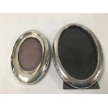 TWO SILVER PHOTO FRAMES OF OVAL FORM, THE EARLIEST OF WHICH HALLMARKED BIRMINGHAM 1912 BY RU & CO,