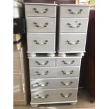 A TWO OVER THREE CHEST OF DRAWERS WITH A MATCHING PAIR OF BEDSIDE CHESTS