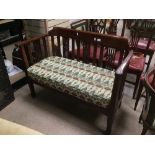 AN EDWARDIAN TWO SEATER MAHOGANY SEAT WITH A WILLIAM MORRIS STYLE COVER.