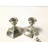 A PAIR OF SILVER SQUAT CANDLESTICKS OF OCTAGONAL FORM, HALLMARKED BIRMINGHAM 1962 BY SANDERS AND
