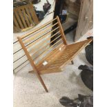 A TEAK MID-CENTURY MAGAZINE RACK.