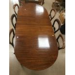 A MAHOGANY VICTORIAN EXTENDING DINING TABLE WITH TWO LEAVES AND SIX VICTORIAN BALLOON BACK CHAIRS