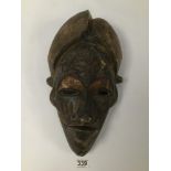 AN EARLY 20TH CENTURY TIKAR CAMEROON TRIBAL WOODEN MASK WITH COPPER INSERTS AND INTRICATE TWISTED
