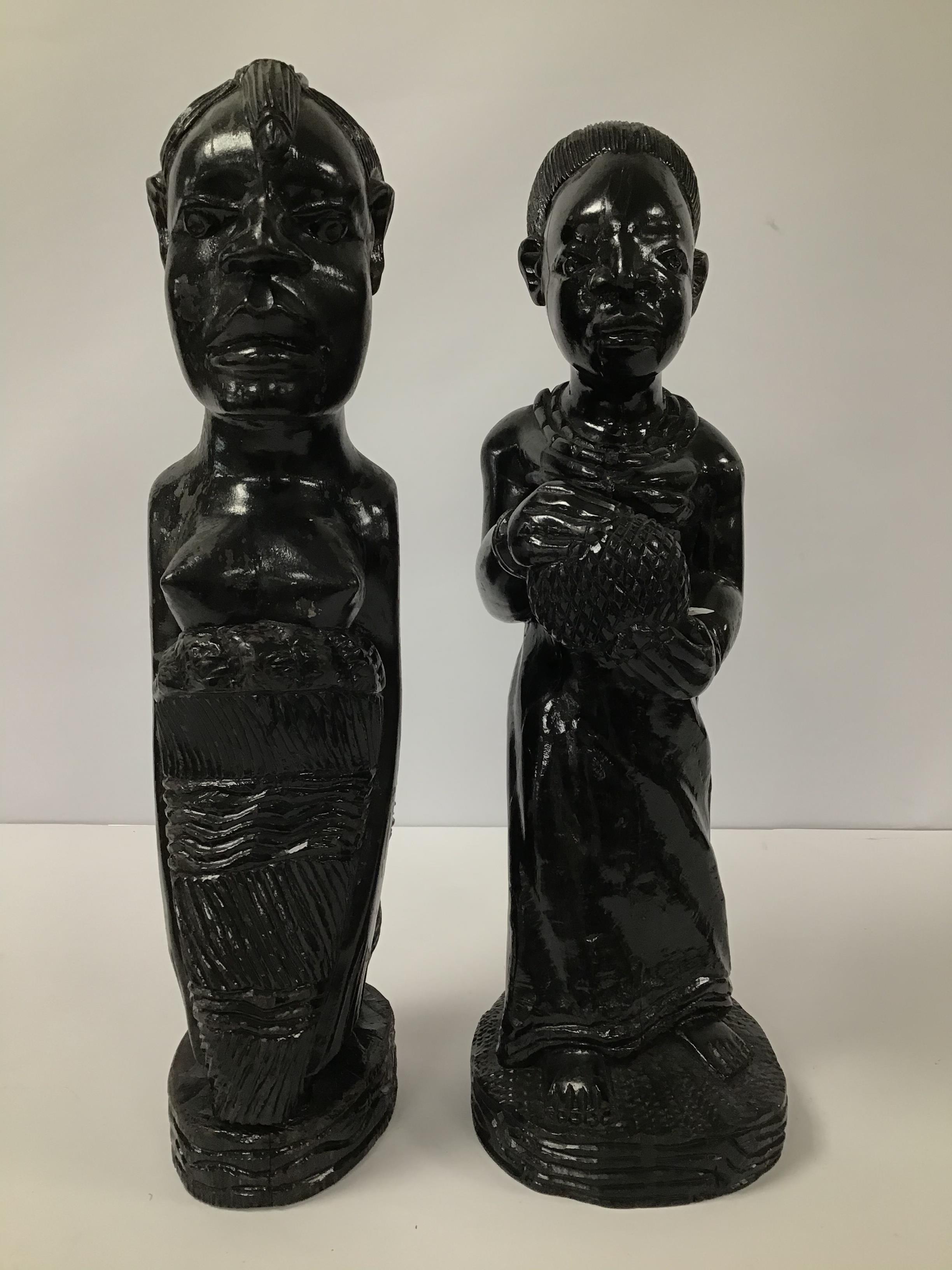 A PAIR OF CARVED WOODEN TRIBAL FIGURES OF WOMEN, LARGEST 42CM HIGH