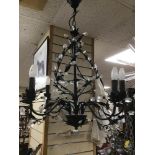 A BLACK AND METAL CHANDELIER WITH ART DECO STYLE WALL LIGHTS.