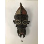 AN AFRICAN LATE NINETEENTH CENTURY DARK WOOD INTRICATELY CARVED BAMILEKE CEREMONIAL MASK WITH