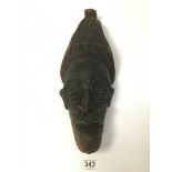 CIRCA 1940 A TOURIST CARVED MASK WITH TWO SCREW HOLES AT TEMPLE LEVEL POSSIBLY FOR HAIR, 48CM TALL
