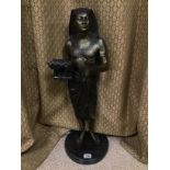 AN EXCEPTIONALLY LARGE BRONZE FIGURE OF AN EGYPTIAN PHAROAH, HOLDING IN ONE HAND A MODEL OF A