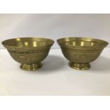 A PAIR OF CHINESE BRONZE BOWLS RAISED UPON PEDESTAL BASES, ETCHED DETAILING THROUGHOUT DEPICTING