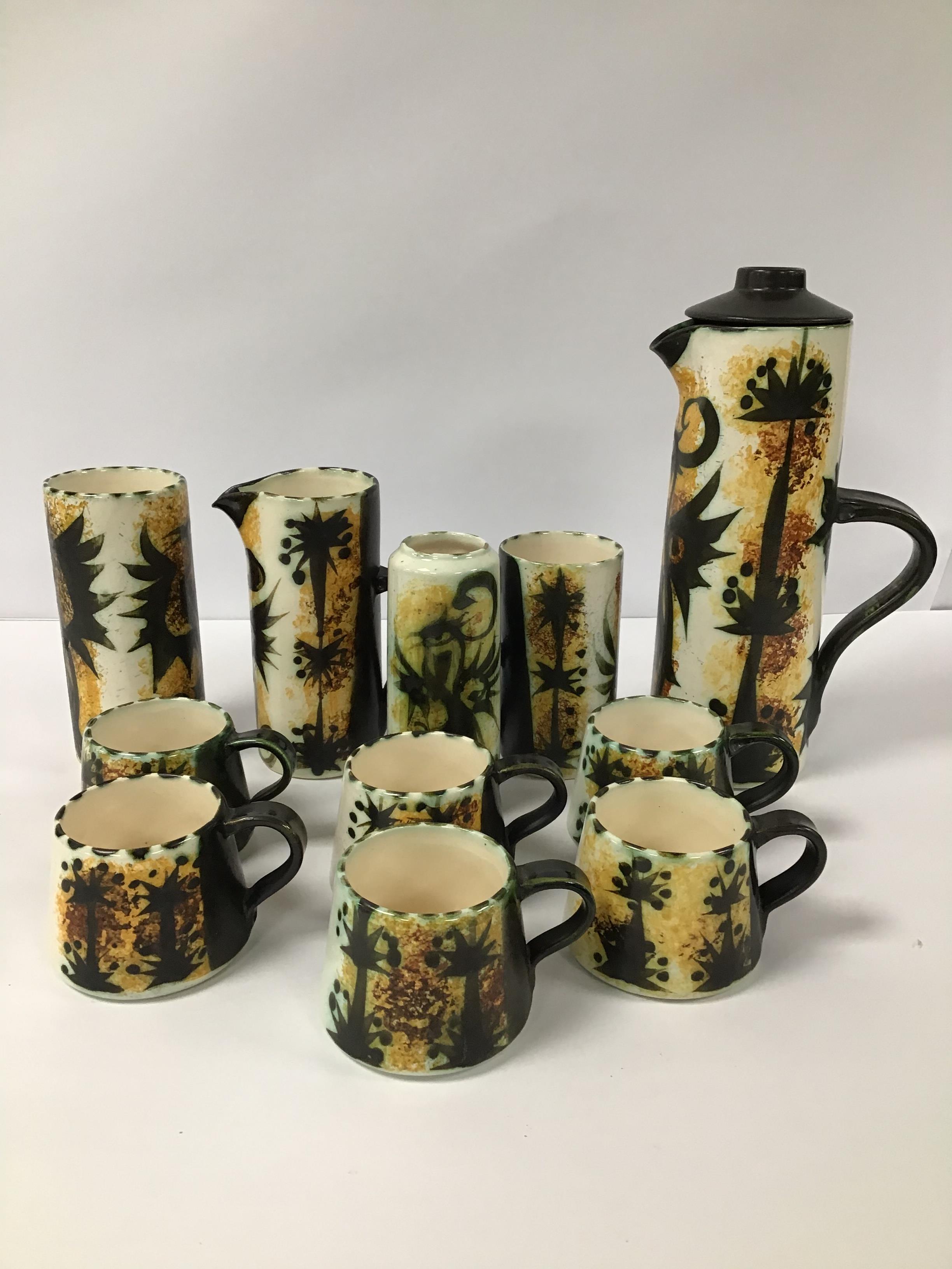 ELEVEN PIECES OF STUDIO POTTERY WITH PHOENIX DESIGNS, INCLUDING TEA POT, CUPS AND MORE