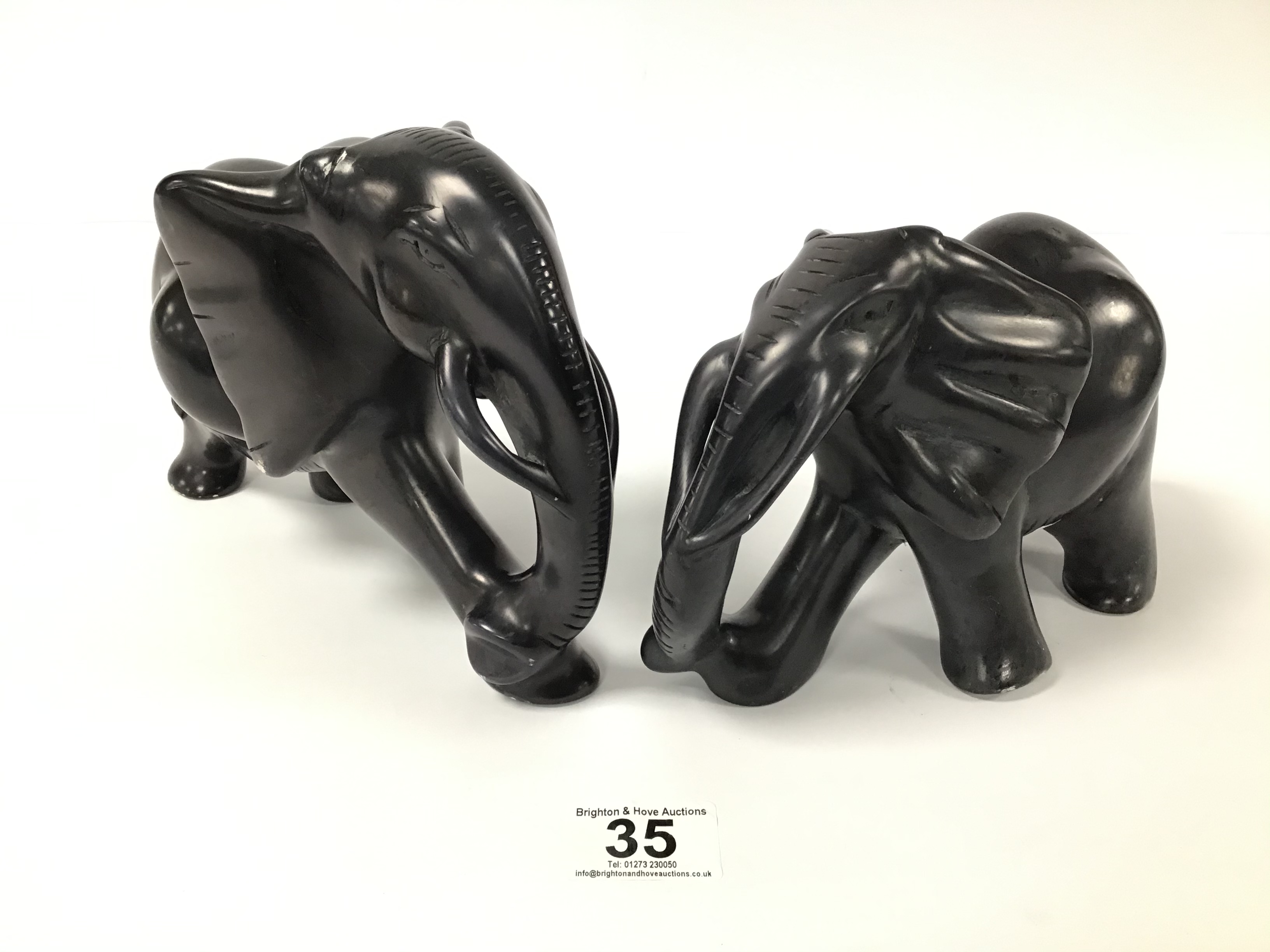 TWO CARVED HEAVY AFRICAN STONE FIGURES OF ELEPHANTS BY BESMO, LARGEST 23CM WIDE