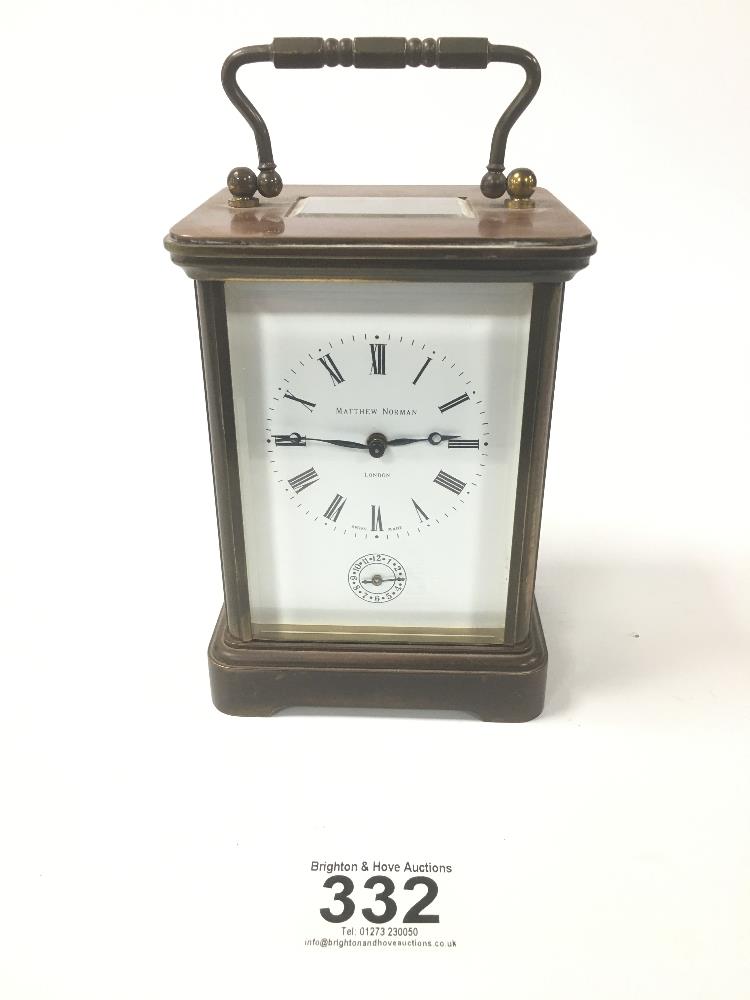 A LARGE BRASS CASED CARRIAGE CLOCK BY MATTHEW NORMAN OF LONDON, THE ENAMEL DIAL WITH ROMAN