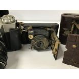 THREE VINTAGE CAMERAS, COMPRISING A KODAK HAWKETTE NO 2, A ZENIT E AND AN EASTMAN KODAK CO VEST