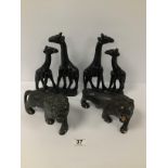 FOUR CARVED WOODEN FIGURES OF ANIMALS, INCLUDING TWO GIRAFFES AND TWO LIONS WITH INLAID BONE