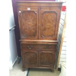 A LOCKABLE BURR WALNUT COCKTAIL CABINET WITH KEY