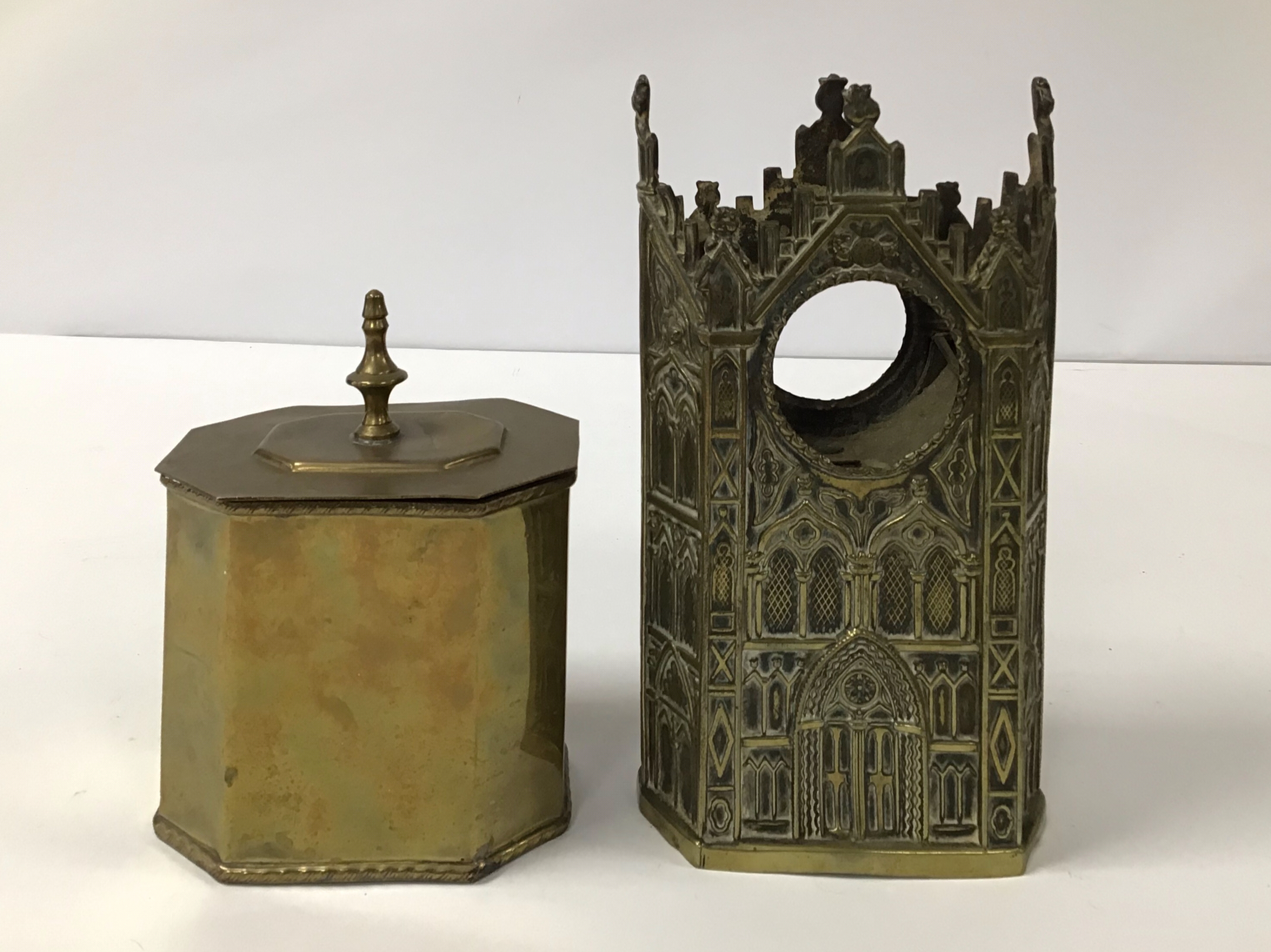 A VICTORIAN BRASS WATCH HOLDER IN THE FORM OF A GOTHIC BUILDING, TOGETHER WITH A BRASS TEA CADDY