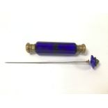 A VICTORIAN BLUE GLASS DOUBLE ENDED PERFUME BOTTLE, 13CM LONG, TOGETHER WITH A PASTE GEM SET HAT