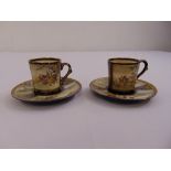 A pair of satsuma coffee cups and saucers, decorated with figures, flowers and leaves, signed, A/F