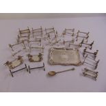 A quantity of silver plate to include twenty pairs of knife rests and a rectangular tray