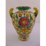 A Majolica Italian vase of baluster form decorated with stylised leaves and flowers