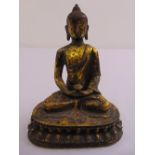 A Chinese gilded metal figurine of Buddha on a lotus plinth