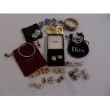 A quantity of costume jewellery to include Chanel earrings, a Dior bracelet, other fashion