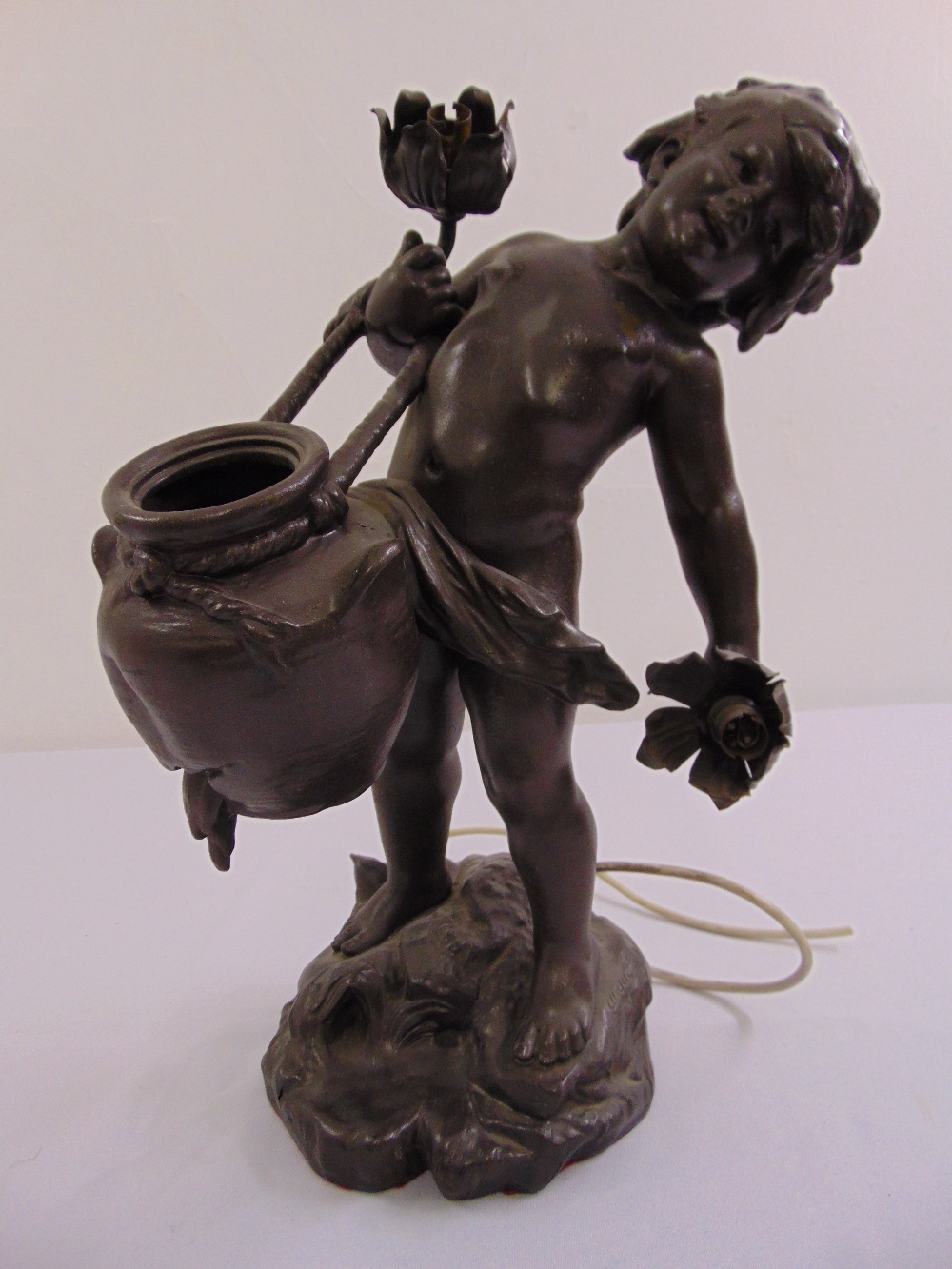 An Art Nouveau style spelter figurine of a putti on naturalistic base, signed Moreau with foundry