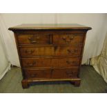 A 19th century rectangular oak chest of drawers two over three with brass swing handles on four