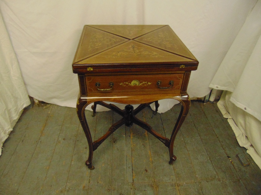 An Edwardian mahogany square inlaid envelope card table with a single drawer on four cabriole legs