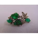 A white gold emerald and diamond flower brooch, gold tested 18ct, approx total weight 8.8g