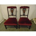 A pair of Edwardian prie-dieu chairs with scroll pierced slats on four turned legs