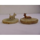 Two marble ashtrays mounted with cold painted bronze figurines of a dog and a stag