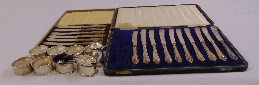 A quantity of silver to include napkin rings, condiments and cased tea knives with silver handles