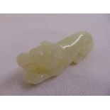 A Chinese jade figurine of a reclining dog
