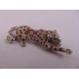 A white gold ruby, emerald and diamond brooch in the form of a leopard, gold tested 18ct, approx