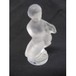 A Lalique figurine of a kneeling girl with a fawn on circular base