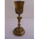 A 19th century continental silver gilt chalice, the triform knopped stem chased with leaves and