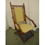 A Victorian oak campaign chair of rectangular form with upholstered seat and back