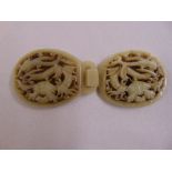 A Chinese mutton fat jade belt buckle carved with dragons