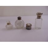 Three silver mounted glass scent bottles and silver plated pill box