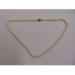 A single string pearl necklace with 9ct gold sapphire and pearl clasp